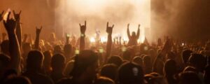 silhouettes of concert crowd in front of bright stage lights